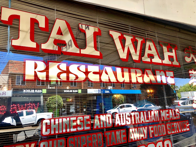 The front window of Tai Wah Restaurant in Mentone with bold red and white lettering. The sign advertises “Chinese and Australian Meals.” Tai Wah is well known for its dimmies (dim sims), considered among the best old-school options in Melbourne.